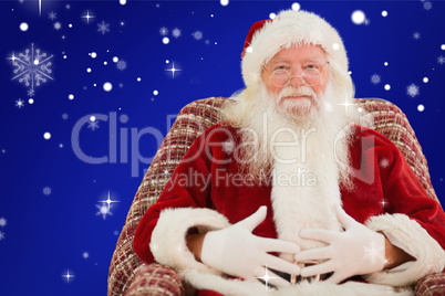 Composite image of santa holding his belly on the armchair