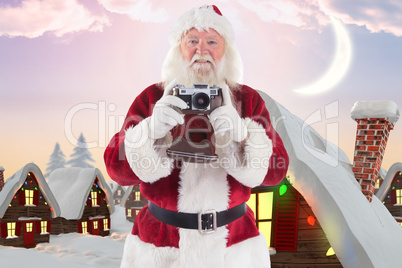 Composite image of santa is taking a picture