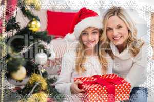 Composite image of festive mother and daughter beside christmas