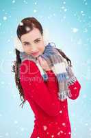 Composite image of pretty brunette in winter wear smiling at cam