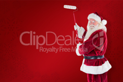 Composite image of father christmas paints a wall
