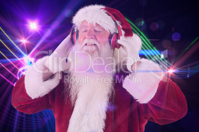 Composite image of santa claus enjoys some music