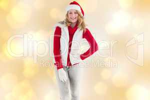 Composite image of smiling pretty blonde standing in warm clothe