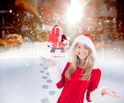 Composite image of pretty santa girl smiling at camera