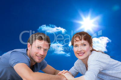 Composite image of couple lying on the floor