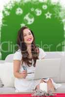 Composite image of smiling woman with laptop and card