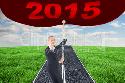 Composite image of businesswoman pulling a chain