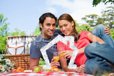 Composite image of two friends looking ahead while they hold gla