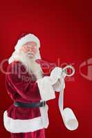 Composite image of santa writing his list