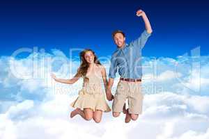 Composite image of cheerful young couple jumping