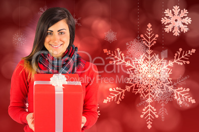 Smiling brunette holding a gift