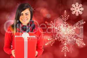 Smiling brunette holding a gift