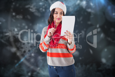 Composite image of festive brunette thinking about her christmas