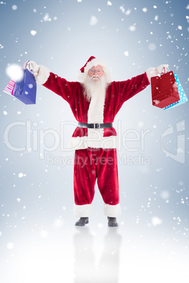 Santa holds some bags for chistmas