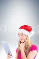 Festive blonde looking at tablet pc