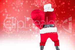 Composite image of rear view of santa holding a sack