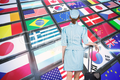 Composite image of pretty air hostess leaning on suitcase