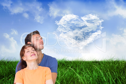 Composite image of happy couple together looking upwards