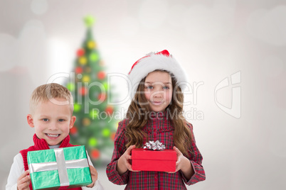 Composite image of cute siblings with gifts