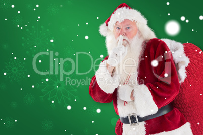 Composite image of santa asking for quiet with bag