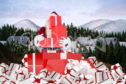 Composite image of santa standing in large gift