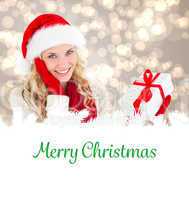 Composite image of happy festive blonde with gift