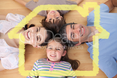 Composite image of lively family lying on the floor