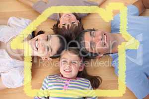 Composite image of lively family lying on the floor