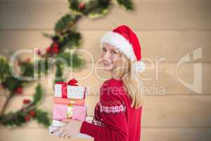 Composite image of woman holding christmas presents