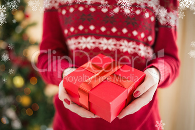 Composite image of close up of a woman offering a gift
