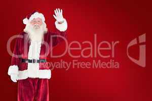 Composite image of jolly santa waving at camera