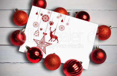 Composite image of hanging red christmas decorations