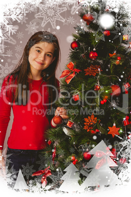 Composite image of little girl smiling at camera beside christmas tree