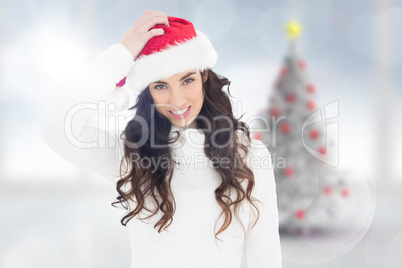 Composite image of confused brunette in santa hat