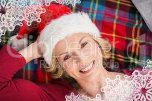 Composite image of festive blonde smiling on blanket