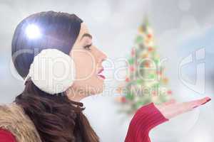 Composite image of brunette in winter clothes with hand out