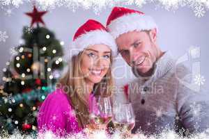 Composite image of happy couple enjoying some wine