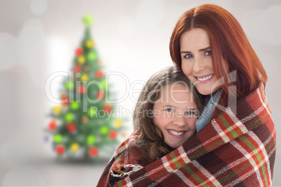 Composite image of mother and daughter under blanket