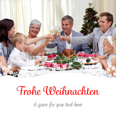 Composite image of family drinking a toast in a christmas dinner