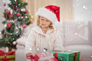 Composite image of cute little girl surrounded by christmas gift