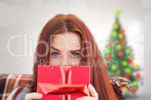 Composite image of woman holding gift