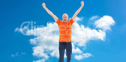 Composite image of mature man in orange tshirt cheering