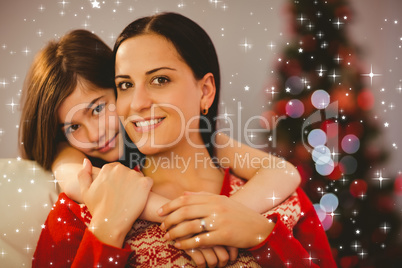 Composite image of festive mother and daughter smiling at camera