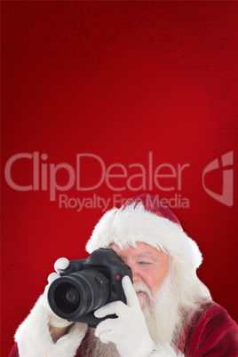 Composite image of santa is taking a picture