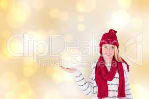 Composite image of festive blonde presenting with hand