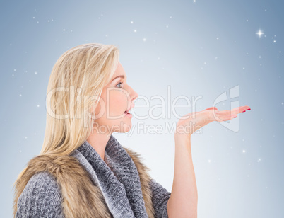 Blonde in winter clothes with hand out