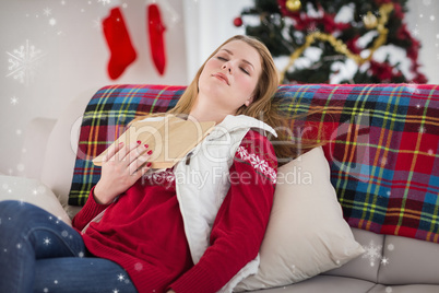 Composite image of young woman falling asleep while reading