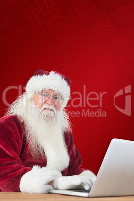 Composite image of santa surfs on the internet