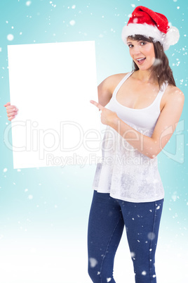 Pretty girl in santa hat holding poster