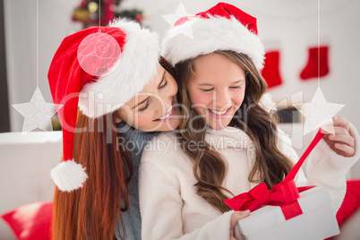 Composite image of festive mother and daughter on the couch with